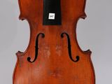 an old violin with a bow hanging from it ' s back