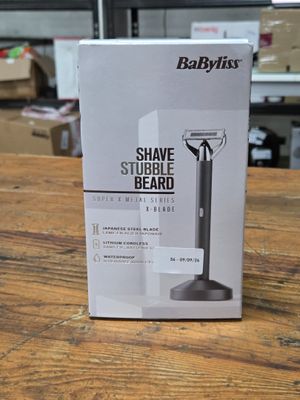 the box of a shaver sitting on top of a wooden table