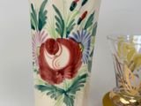 a vase and a glass sitting on a table