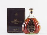 a bottle of courvoisir cognar next to a box
