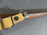 an image of a rifle with a wooden handle on a table