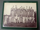 photograph of a group of men standing on top of a wooden structure
