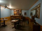 a room with a lot of tables and chairs in it