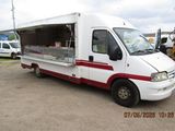 un food truck blanc et rouge garé sur un parking
