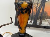 two vases sitting on a table with a picture in the background