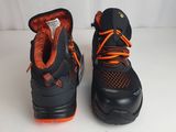 pair of black and orange shoes with orange laces on them