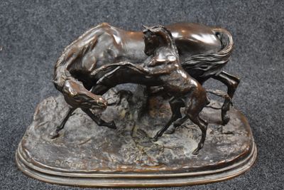 bronze statue of a horse and a rider on a rock