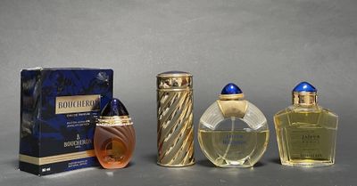 three bottles of perfume sitting next to each other on a table