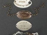 several different types of bracelets with names on them on a black surface