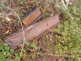 two pieces of rust sitting on the ground in the grass