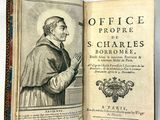 un vieux livre sur lequel figure l'image d'un homme vêtu d'une aube