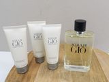 three bottles of perfume sitting on top of a wooden tray