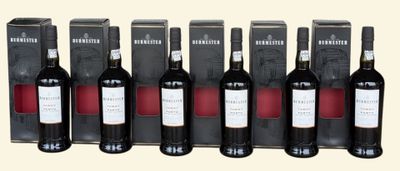 six bottles of red wine are lined up in a row