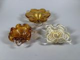 three pieces of glass sitting on top of a table next to each other