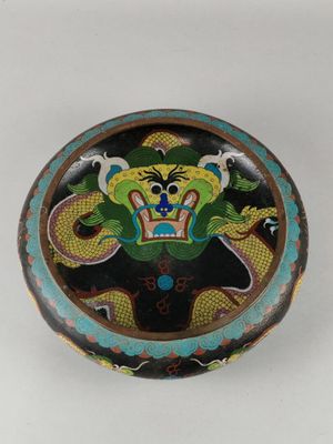 a decorative box with a dragon on it on a table