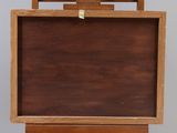 a small wooden easel with a wooden box on top of it