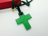a green cross on a green cord with a red box