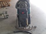 a machine that is sitting on the floor in the garage