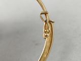 an image of a close up of a gold bang bracelet