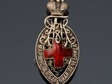 a close up of a badge with a red cross on it
