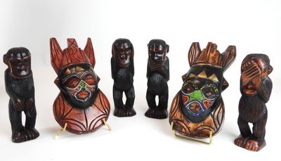 several wooden figurines of different shapes and sizes on a white surface