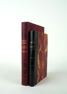 two books sitting on top of each other on a white surface