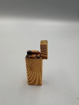 a lighter that is sitting on a white surface