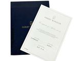 a black book with a white cover and a blue book with a black cover