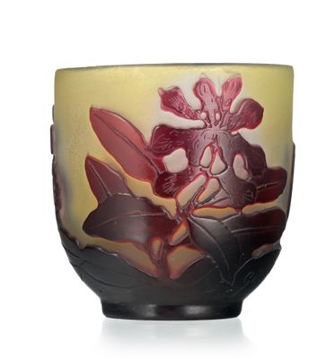 a vase with a flower on it sitting on a table