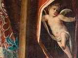 a painting of an angel hanging from a cross in a room