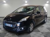 a picture of a small black car parked in a garage