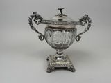 an antique silver plated trophy with a bird on top of it