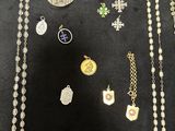 several different types of necklaces and pendants laid out on a table