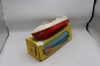 un bateau rouge et blanc posé sur une boîte jaune