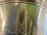 a silver cup that is sitting on a table