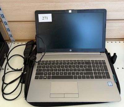 a laptop that is sitting on a desk with a charger