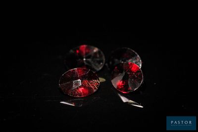 deux morceaux de verre rouge posés sur une surface noire