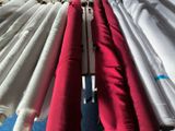 many red and white umbrellas hanging on a rack