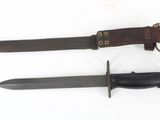 two knives are laying side by side on a white surface