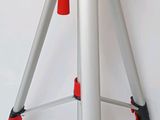 a tripod with a camera on it on a white surface