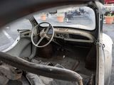 an old car that is sitting in a parking lot