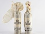 two bottles of wine that have been wrapped in paper