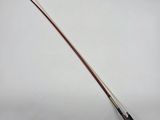 a close up of a violin bow on a white surface