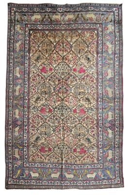an antique persian rug with a floral design on a beige ground