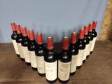 several bottles of wine are lined up in a row on a table