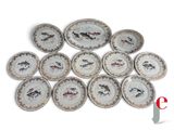many plates with fish on them on a white surface