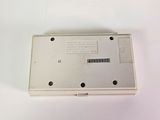 a small white electronic device on a white surface