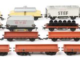 several toy trains are lined up in a row on a white surface