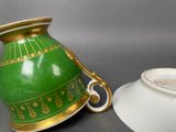 a green vase and a white bowl sitting next to each other