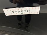 a person holding a sign that says vauto on it